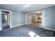 Living room with gray carpet, light blue walls and an opening to the kitchen at 111 Courtland St, Chester, SC 29706