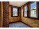 Charming room with wood paneling, new carpet, brick accent, and natural light from multiple windows at 111 Courtland St, Chester, SC 29706