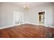 Large living room with hardwood floors and access to other rooms at 137 Lancaster St, Chester, SC 29706
