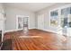 Sunlit living room with original hardwood floors and period trim on doors and windows at 137 Lancaster St, Chester, SC 29706