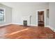 The living room offers hardwood floors, a brick fireplace, and an entrance to another room at 137 Lancaster St, Chester, SC 29706
