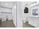 Bright bathroom with white cabinets, a toilet, a shower and washer and dryer in the next room at 14032 Canemeadow Dr, Charlotte, NC 28278