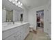 Bathroom featuring double sink vanity and a walk-in closet at 14032 Canemeadow Dr, Charlotte, NC 28278