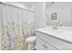 Bright bathroom featuring a shower with curtain and white vanity with modern fixtures at 14032 Canemeadow Dr, Charlotte, NC 28278