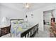 Cozy bedroom with bright chevron bedding, bedside lamps, and carpeted floor at 14032 Canemeadow Dr, Charlotte, NC 28278