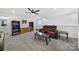 This bonus room features plush carpeting, a comfy reclining sofa, and is ideal for movie nights or cozy gatherings at 14032 Canemeadow Dr, Charlotte, NC 28278