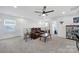 Spacious bonus room features comfortable seating, ceiling fan, and is perfect for entertainment or relaxation at 14032 Canemeadow Dr, Charlotte, NC 28278