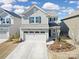 Charming two-story home boasts a welcoming front yard and a two-car garage at 14032 Canemeadow Dr, Charlotte, NC 28278