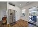 Stainless steel french door refrigerator in a bright kitchen with an open door to a sunroom at 14032 Canemeadow Dr, Charlotte, NC 28278
