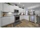 Modern kitchen featuring white cabinets, stainless steel appliances, and granite countertops at 14032 Canemeadow Dr, Charlotte, NC 28278