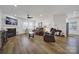 Spacious living room with a fireplace, laminate floors and ample natural light at 14032 Canemeadow Dr, Charlotte, NC 28278