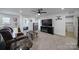 Cozy living room with carpet flooring, ceiling fan, and entertainment center at 14032 Canemeadow Dr, Charlotte, NC 28278
