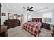 Main bedroom with tray ceiling, ceiling fan, carpet flooring, and ensuite bathroom at 14032 Canemeadow Dr, Charlotte, NC 28278
