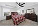 Cozy main bedroom featuring carpet flooring, ceiling fan, and a large dresser at 14032 Canemeadow Dr, Charlotte, NC 28278