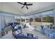 Relaxing sunroom with multiple windows, wicker seating, and overhead fan at 14032 Canemeadow Dr, Charlotte, NC 28278