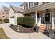 Charming brick home featuring a welcoming front porch with classic white columns and manicured landscaping at 161 Dairy Farm Rd, Mooresville, NC 28115