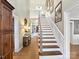 Elegant foyer featuring a staircase, wood floors, and stylish decor at 2021 Witmore Rd, Wingate, NC 28174