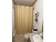 This cozy bathroom has a neutral color scheme and features a shower with palm tree curtain at 2084 W Memorial Hwy Rd, Union Grove, NC 28689