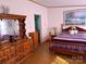 Charming bedroom featuring wood furniture, including a dresser and bed, with cozy decor and natural light at 2084 W Memorial Hwy Rd, Union Grove, NC 28689