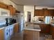 Functional kitchen boasts light oak cabinets, white appliances, and an island at 2084 W Memorial Hwy Rd, Union Grove, NC 28689