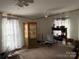 A cozy living room featuring multiple windows, ceiling fans and vintage furniture at 2084 W Memorial Hwy Rd, Union Grove, NC 28689