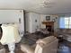 Inviting living room features a fireplace, comfortable seating, and wood-look flooring at 2084 W Memorial Hwy Rd, Union Grove, NC 28689
