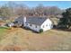 Aerial view of the home's rear, displaying a well-kept lawn and deck, set against a backdrop of trees at 2297 Blossom Dr, Rock Hill, SC 29730