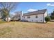 Exterior of a white home featuring a spacious yard and mature tree at 2297 Blossom Dr, Rock Hill, SC 29730
