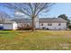 White home with a spacious backyard with deck and mature tree at 2297 Blossom Dr, Rock Hill, SC 29730