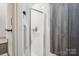 Bright bathroom features a shower-tub combo with glass door and white tile at 2297 Blossom Dr, Rock Hill, SC 29730