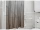 Bright bathroom features a shower-tub combo with gray curtain and white tile at 2297 Blossom Dr, Rock Hill, SC 29730
