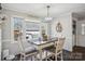 Bright dining area features a lovely table, chandelier, and view to backyard at 2297 Blossom Dr, Rock Hill, SC 29730