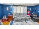 Cozy living room features a comfortable gray sofa, blue wall, and carpet at 2297 Blossom Dr, Rock Hill, SC 29730