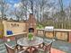 Outdoor dining area features a table with seating, a fireplace, and an outdoor kitchen at 2405 Ivy Run Dr, Indian Trail, NC 28079