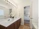 Bathroom showing double sinks, framed mirror, and doorway view into the main bedroom at 2405 Ivy Run Dr, Indian Trail, NC 28079