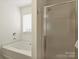 Bathroom with soaking tub and glass door walk-in shower at 2405 Ivy Run Dr, Indian Trail, NC 28079