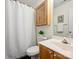 Bathroom featuring shower with white patterned curtain, wood vanity, toilet, and tiled floor at 2405 Ivy Run Dr, Indian Trail, NC 28079