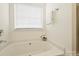 Bathroom includes large soaking tub with tile surround and decorative accent at 2405 Ivy Run Dr, Indian Trail, NC 28079