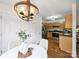 Dining area features a decorative light fixture, hardwood floors, and stainless steel appliances at 2405 Ivy Run Dr, Indian Trail, NC 28079