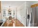 Open dining area featuring modern light fixture, hardwood floors, and stainless steel refrigerator at 2405 Ivy Run Dr, Indian Trail, NC 28079