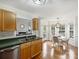 Kitchen with sink, hardwood floors, and dining area with lots of windows at 2405 Ivy Run Dr, Indian Trail, NC 28079