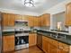 Functional kitchen equipped with stainless steel appliances and oak cabinets at 2405 Ivy Run Dr, Indian Trail, NC 28079