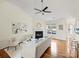 Open living space with vaulted ceiling, fireplace, and sleek ceiling fan at 2405 Ivy Run Dr, Indian Trail, NC 28079