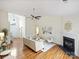 Bright living room boasts hardwood floors, fireplace, and ceiling fan at 2405 Ivy Run Dr, Indian Trail, NC 28079