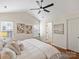 Bright main bedroom features a vaulted ceiling, ceiling fan, neutral walls, and wood-look flooring at 2405 Ivy Run Dr, Indian Trail, NC 28079