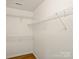 A walk-in closet features wire shelving, base molding, and wood-look floors at 2405 Ivy Run Dr, Indian Trail, NC 28079