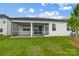 Exterior view of the home featuring a screened patio and a well-manicured backyard at 2656 Tillman St, Monroe, NC 28112