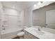 Well-lit bathroom featuring a shower-tub combo and a vanity with a sleek countertop and modern fixtures at 2656 Tillman St, Monroe, NC 28112