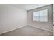 Carpeted bedroom features a window bringing in natural light at 2656 Tillman St, Monroe, NC 28112