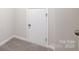 Bedroom featuring neutral walls, plush carpeting, and a closed door at 2656 Tillman St, Monroe, NC 28112